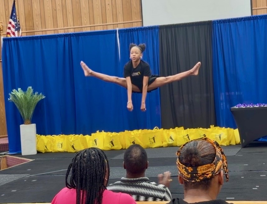 Young dancer leaping on stage at the Why Wait? Youth Event